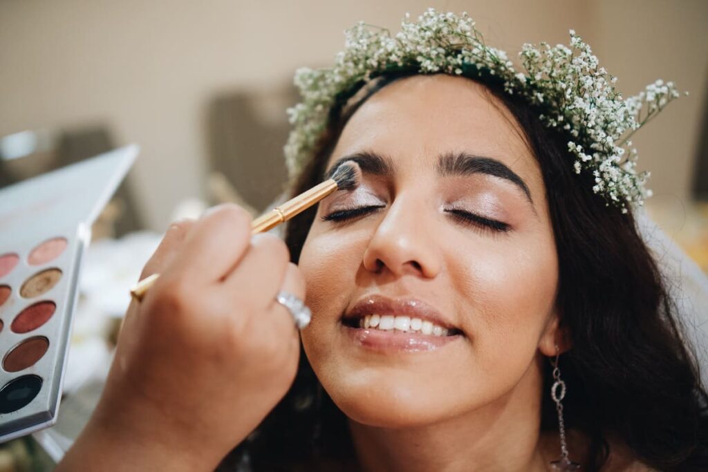 Novia sonriente luciendo un acabado nupcial impecable gracias a las técnicas para fidelizar clientas en maquillaje de bodas de su estilista.